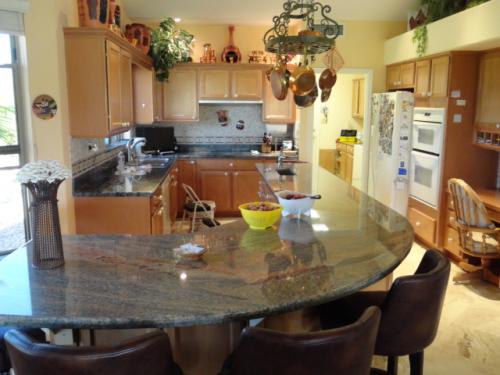 Custom Kitchen area flooring, countertops and backsplash by MTZ Tile and Stone-Phoenix, Arizona 602-451-4565